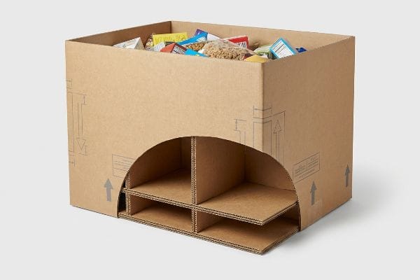 Brown corrugated cardboard dump bin with an internal H-divider structure, filled with bulk packaged food products, preventing lateral bowing.