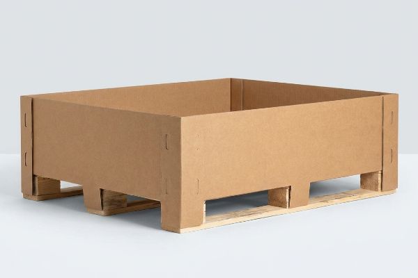 Brown E-flute corrugated cardboard pallet skirt on a wooden shipping pallet, designed for retail floor displays.
