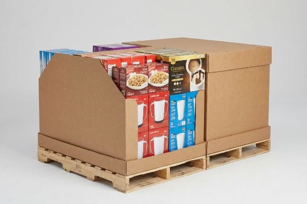 Corrugated half pallet displays on wooden pallets, featuring Bob's Red Mill Steel Cut Oats, mugs, and Classics desserts.