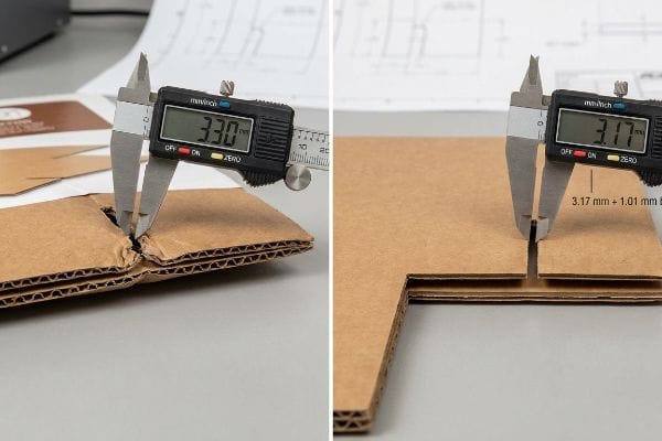 A digital caliper measures a swollen B-flute corrugated cardboard at 3.30 mm, contrasting with a slot showing a 3.17 mm + 1.01 mm humidity buffer.