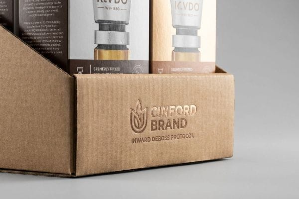 Natural brown corrugated PDQ tray featuring a debossed Cinford Brand logo and Inward Deboss Protocol text.