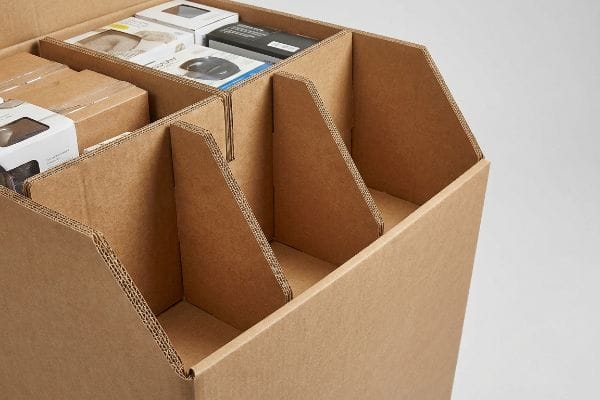 Inside a corrugated cardboard dump bin, modular dividers create organized compartments for retail products.