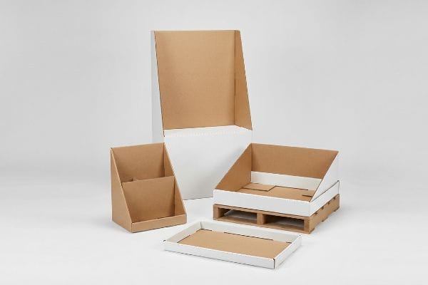 Empty corrugated cardboard POP displays: tall floor unit, countertop, pallet merchandiser, and retail shelf tray.