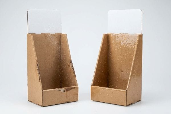 Two empty brown corrugated cardboard POP display stands featuring a glossy, water-resistant poly-coat varnish for outdoor use.