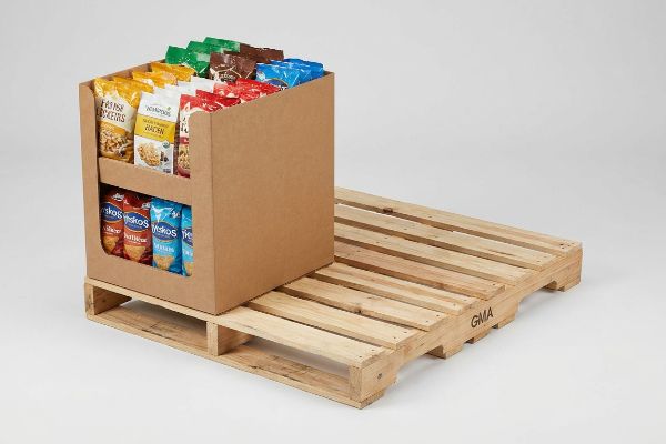 Corrugated quarter pallet display with Farmhouse Crackers, Whisps, and Yokos snack bags on a GMA wood pallet.