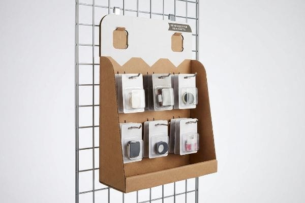 A corrugated cardboard point-of-sale hanging merchandiser, featuring six packaged Refrigeration Products on peg hooks, mounted on a retail grid wall.