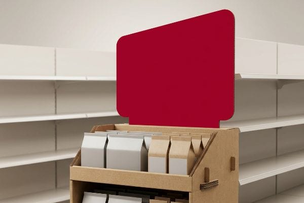 Retail Display Red Header Corrugated cardboard retail display featuring a blank, high-contrast red header and rows of white and kraft paper product bags.