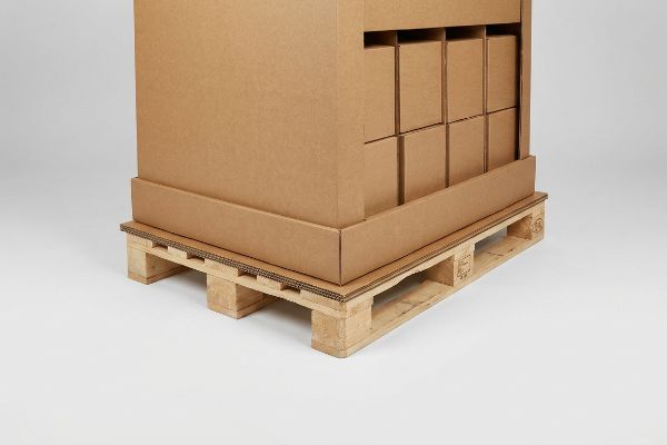 Brown corrugated pallet display box with internal product packaging, resting on a protective corrugated slip sheet on a wooden pallet.