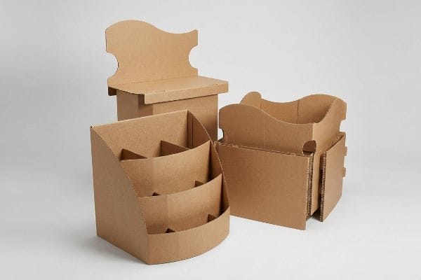 Brown corrugated cardboard displays: a multi-tiered counter unit, a die-cut header stand, and a curved dump bin.