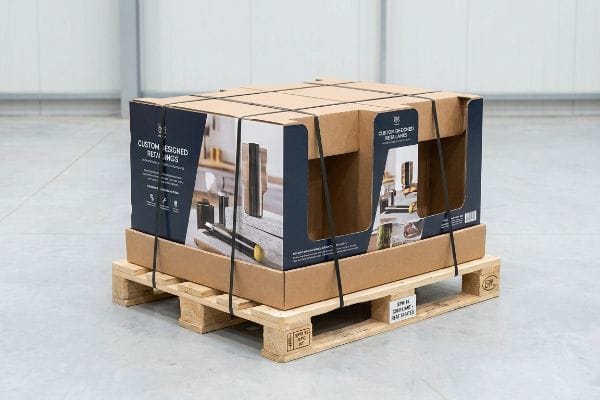 「Custom Designed Retailings」および「Our Custom Designed Retail Lines」と記載された段ボール製のディスプレイボックスは、ISPM 15規格の熱処理済み木製パレットに固定されています。.