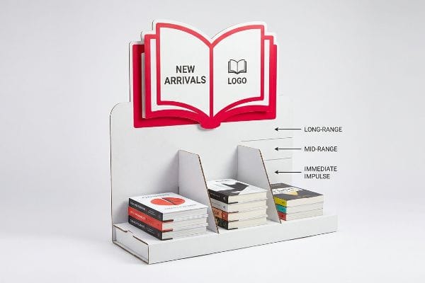 White die-cut cardboard display stand with a red-outlined "New Arrivals" and "Logo" header, presenting books for Long-Range, Mid-Range, and Immediate Impulse engagement.