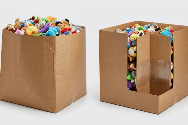 Brown corrugated cardboard dump bins filled with colorful plush toys, one showcasing an internal H-divider for structural integrity.