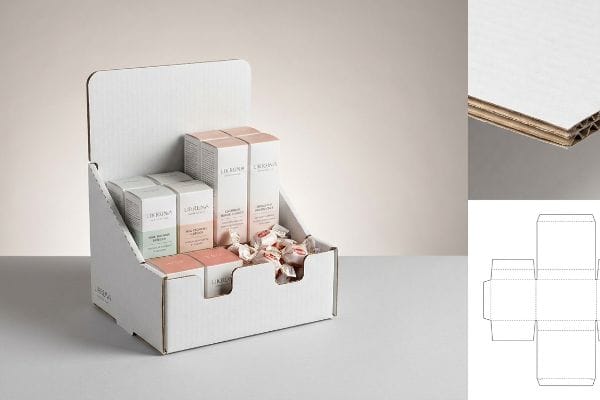 White micro-fluted corrugated countertop display holds LIDRUNA cosmetic boxes and candies, with a box dieline and E-flute detail.