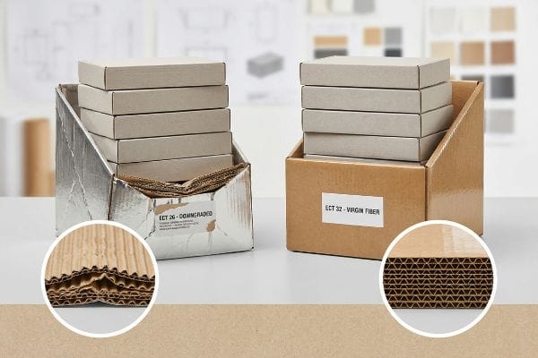 Comparison of two corrugated boxes: a silver ECT 26 Downgraded box with thin fluting, and a brown ECT 32 Virgin Fiber box with thick fluting.