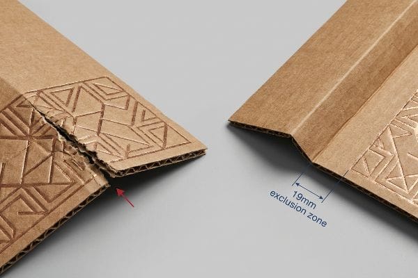 Brown corrugated paperboard pieces demonstrate the impact of 3D embossing near folds, showing a torn edge with a red arrow on the left and a clean 19mm exclusion zone on the right.
