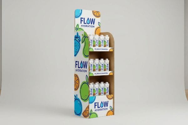 A custom cardboard floor display stand for Flow Hydration, showcasing three tiers of product cartons with vibrant fruit graphics.
