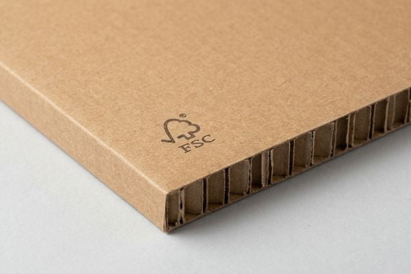 Brown corrugated cardboard with visible fluting and an FSC certification logo, highlighting sustainable packaging.