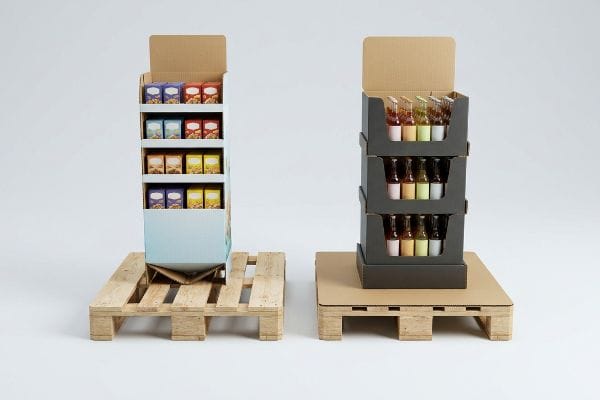 Light blue corrugated FSDU display with colorful product boxes on a wooden pallet, showing unsupported base sag.