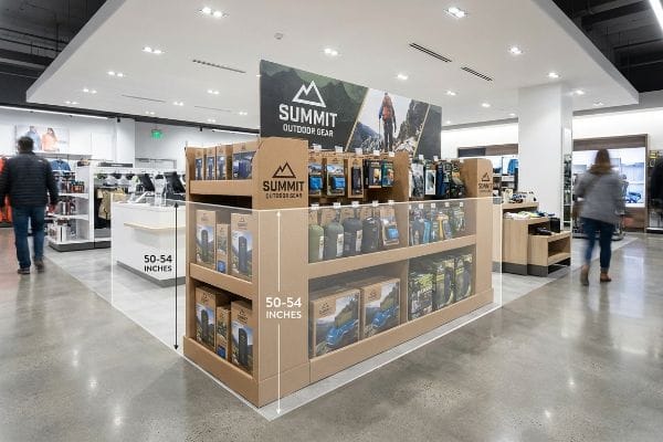 A retail store features a Summit Outdoor Gear FSDU, displaying outdoor products at 50-54 inches, optimizing shopper sightline.