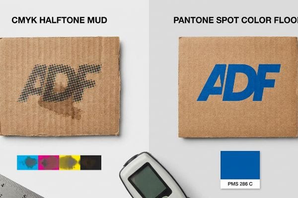 Spot Color Superiority Corrugated cardboard displays the ADF logo, contrasting muddy CMYK Halftone printing with a vibrant, solid Pantone Spot Color Flood in PMS 286 C, showcasing superior print quality.