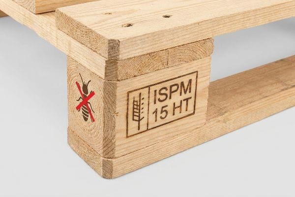 Light-colored wooden pallet block displaying a red