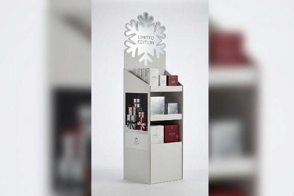 White corrugated retail display with a silver snowflake header featuring 'Limited Edition' text, showcasing red and silver gift boxes.