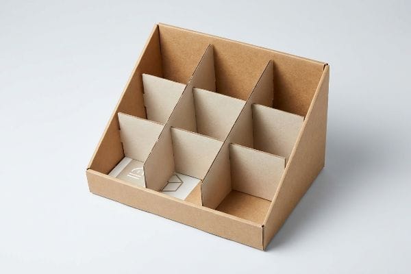 Brown corrugated cardboard display with modular internal dividers, designed for flexible product merchandising.