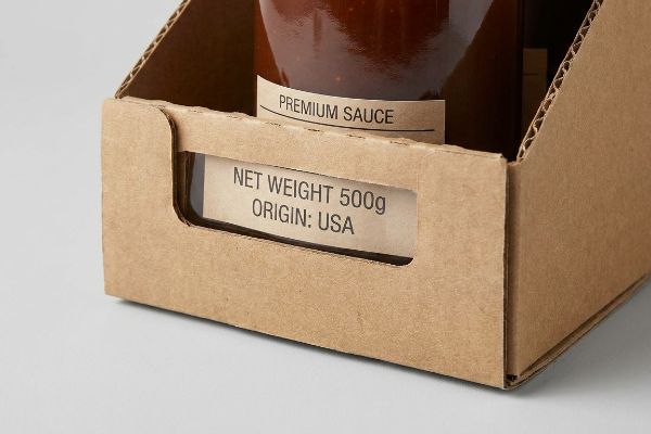 Brown corrugated cardboard tray with a bottle of Premium Sauce, clearly displaying