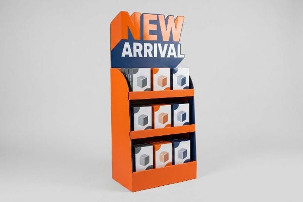 New Arrival POP Display Orange and dark blue cardboard point of purchase display features a 3D die-cut "New Arrival" header and three shelves of cube-patterned product boxes.
