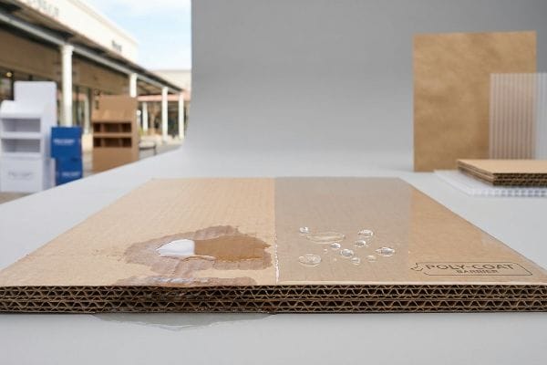 Corrugated cardboard with Poly-Coat Barrier showing water absorbed on untreated left, and water beading on treated right.