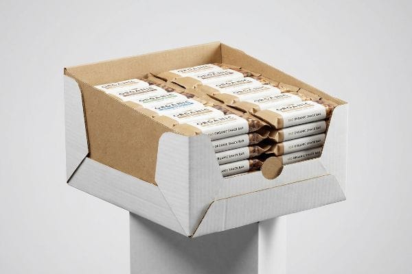 A retail point-of-sale display box showcases numerous Organic Snack Bars in kraft paper packaging.