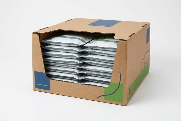 Brown corrugated cardboard PDQ display box, pre-packed with multiple white pouches of consumer goods, featuring blue and green branding.