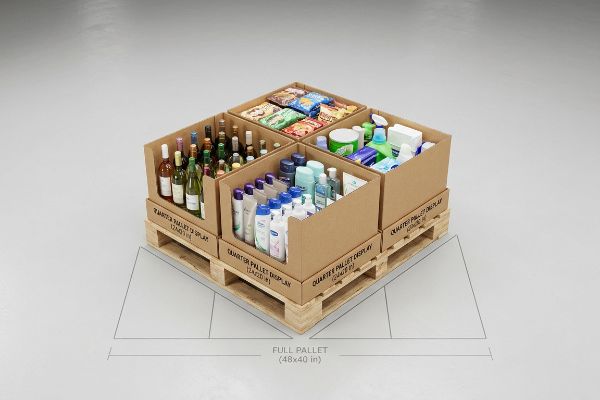 Wooden pallet with four Quarter Pallet Displays showcasing wine, snacks, personal care, and cleaning products, labeled