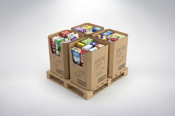 Four brown cardboard dump bins filled with assorted packaged goods, arranged on a wooden quarter pallet for retail display.