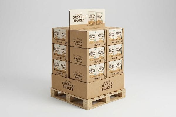 Brown corrugated cardboard quarter-pallet merchandiser display filled with boxes of Organic Snacks, stacked on a light wooden pallet.