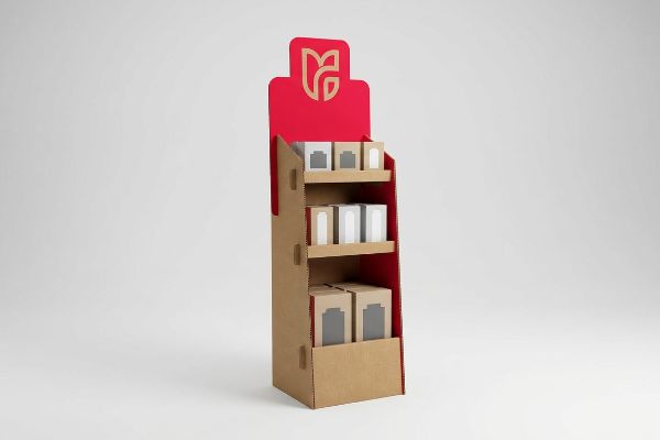 Corrugated cardboard POP display with high-contrast red die-cut header, gold stylized logo, and three shelves of product boxes.