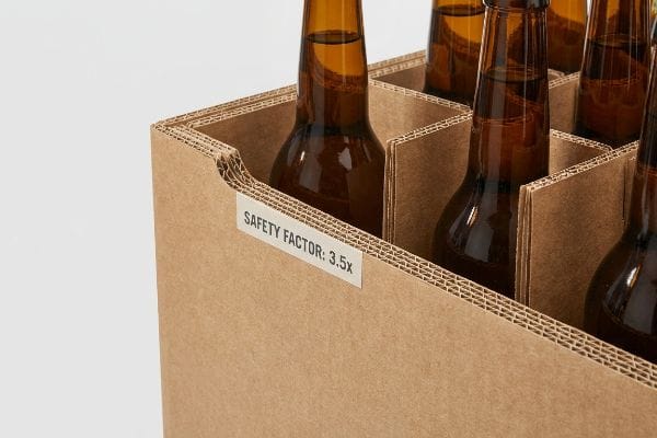 Corrugated cardboard box with internal dividers holding amber bottles, displaying a