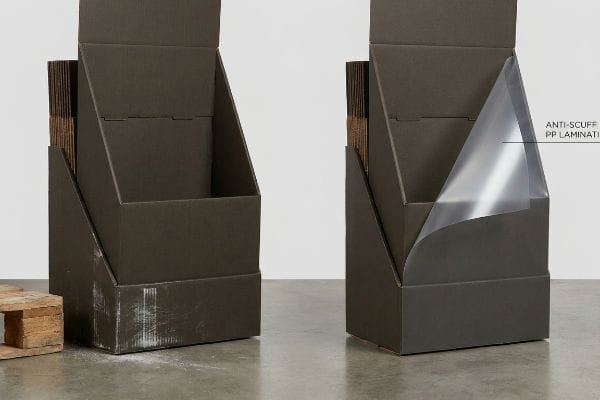 Dark brown cardboard floor displays, one scuffed, the other showcasing Anti-Scuff PP Lamination protection.