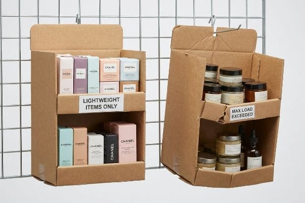 Contrasting cardboard sidekick displays: one holds lightweight Chanel cosmetics, labeled 'Lightweight Items Only'; the other sags with heavy jars, labeled 'Max Load Exceeded'.