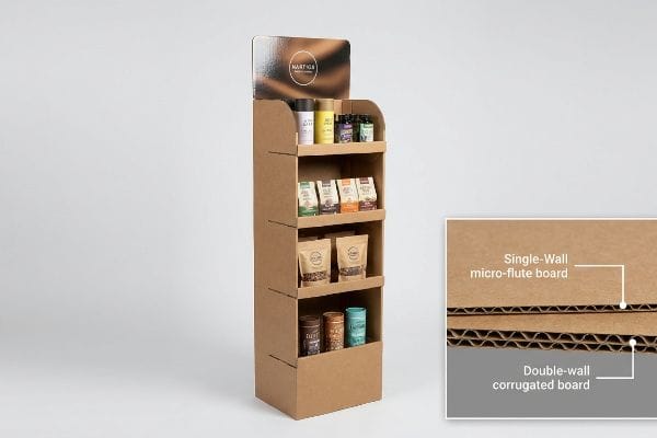 A brown corrugated cardboard display stand features Martigos products, with an inset detailing Single-Wall micro-flute and Double-wall corrugated board.
