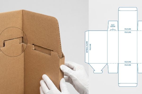 Corrugated paperboard box assembly, highlighting an interlocking slot and a technical dieline with Slot Buffer and Material Caliper Fold Line.