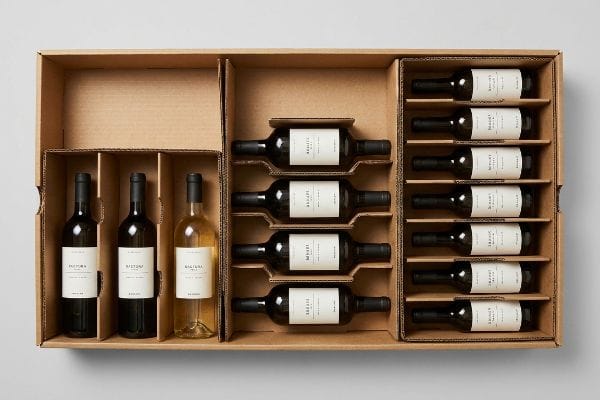 Natural brown corrugated cardboard box with modular dividers holding 15 wine bottles in a 3-5-7 asymmetrical layout for retail display.