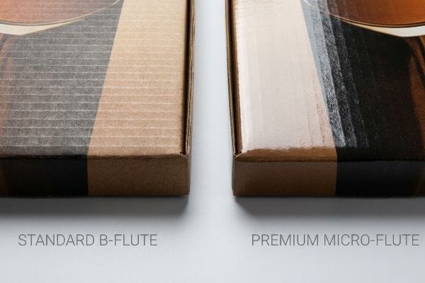 B-Flute Micro-Flute Comparison Standard B-Flute corrugated board with visible ribbed texture contrasted with smooth Premium Micro-Flute packaging, ideal for high-fidelity graphics.