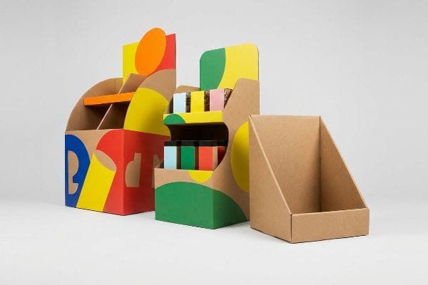 Corrugated cardboard displays with bold spot colors, showcasing product visibility and ergonomic design for retail merchandising.