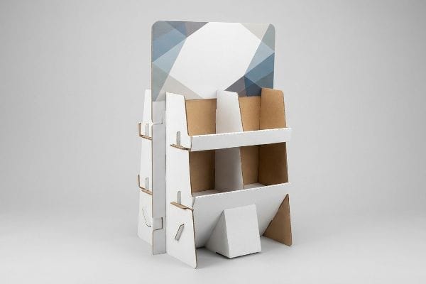 White Cardboard POP Display A white cardboard point-of-purchase display, empty, with two shelves and a blue geometric header.