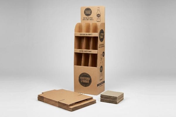 Cardboard POP Display Components A brown corrugated cardboard point-of-purchase display for Custard Stroke products stands beside flat-packed unassembled display components.