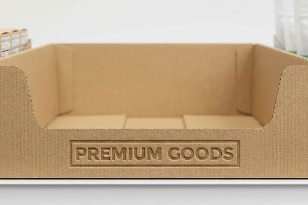Light brown corrugated cardboard PDQ tray featuring debossed 'Premium Goods' text on its front panel, showcasing premium packaging.