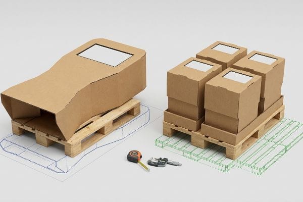 Corrugated display prototypes on wooden pallets with CAD outlines, measured by tape and caliper, demonstrating fractional pallet logistics.