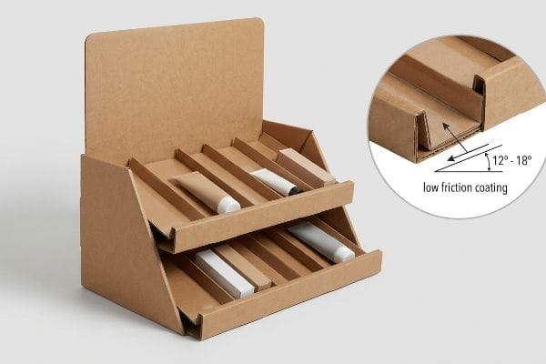 Gravity Rack Display Coating Brown corrugated gravity rack display with two tiers of cosmetic tubes, highlighting 12-18 degree sloped tracks and low friction coating.