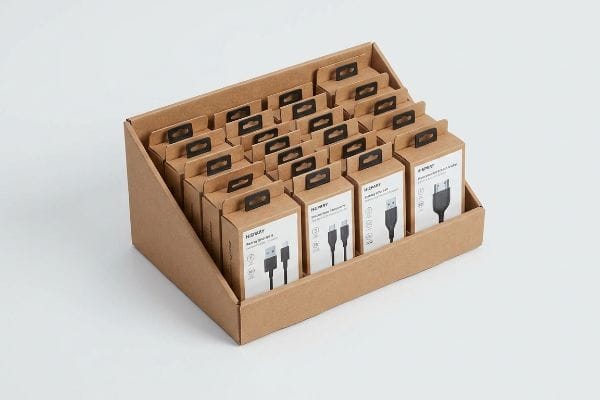 A retail display of H-WAY USB C cables and power adapters in a brown corrugated PDQ tray, featuring hanging tabs.